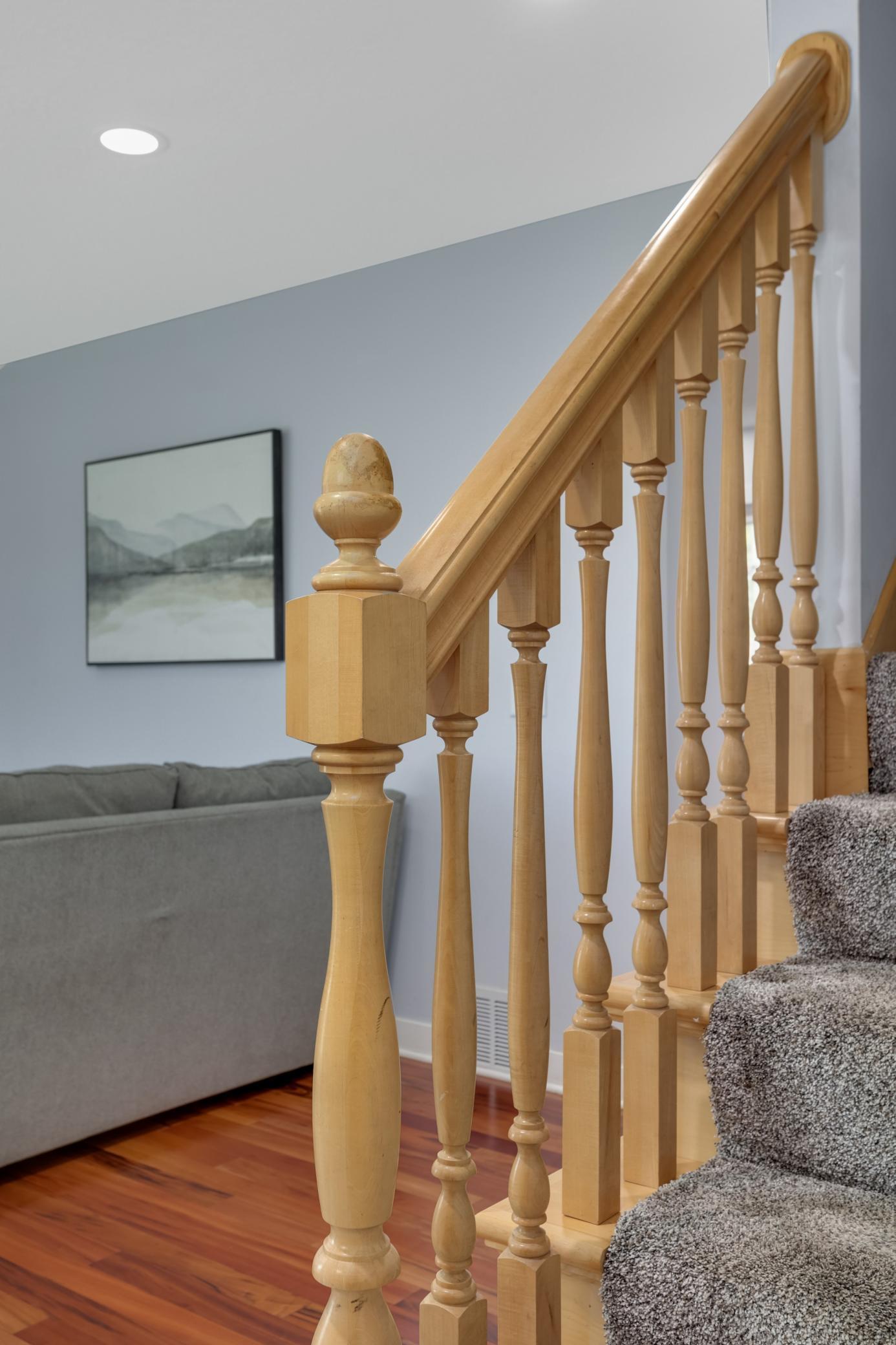 The lovely banister helps keep the spacious feel to the main floor.