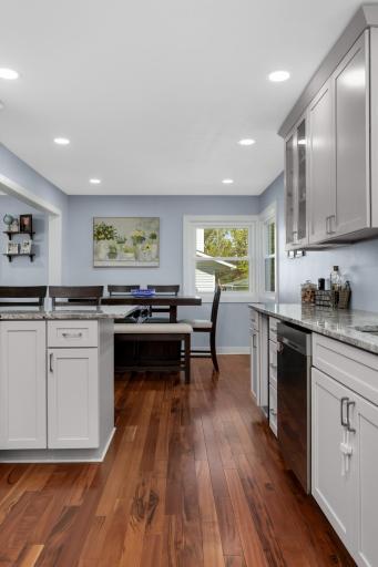 Updated windows and recessed lighting add a warmth to the space that is reflected in the stunning hardwood flooring.