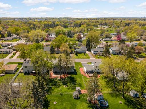 Overhead view of the backyard and neighborhood in front of the home.