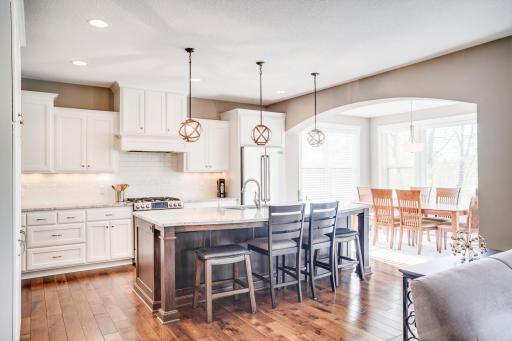 Hardwood flooring continues through the foyer, office, kitchen, dining area, and nearby powder bath, enhancing the homeâs cohesive design and upscale feel.