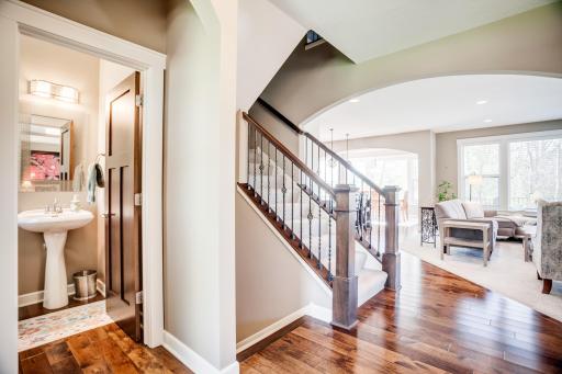 Convenient main level powder bath with pedestal sink is located off the foyer.