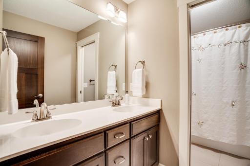 Thoughtfully designed hallway bath features dual sinks and a pocket door separating the vanity area from the tub/shower and commode for added functionality...perfect for sharing.