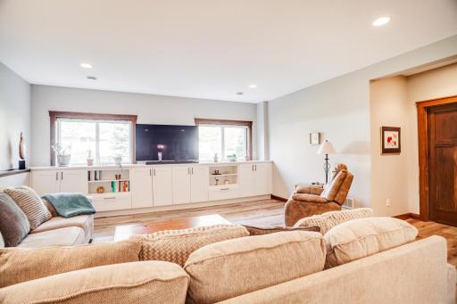 The finished lower level expands the homeâs living and entertaining options with a spacious family room filled with natural light and enhanced by durable LVP flooring and custom built-in media cabinetry.