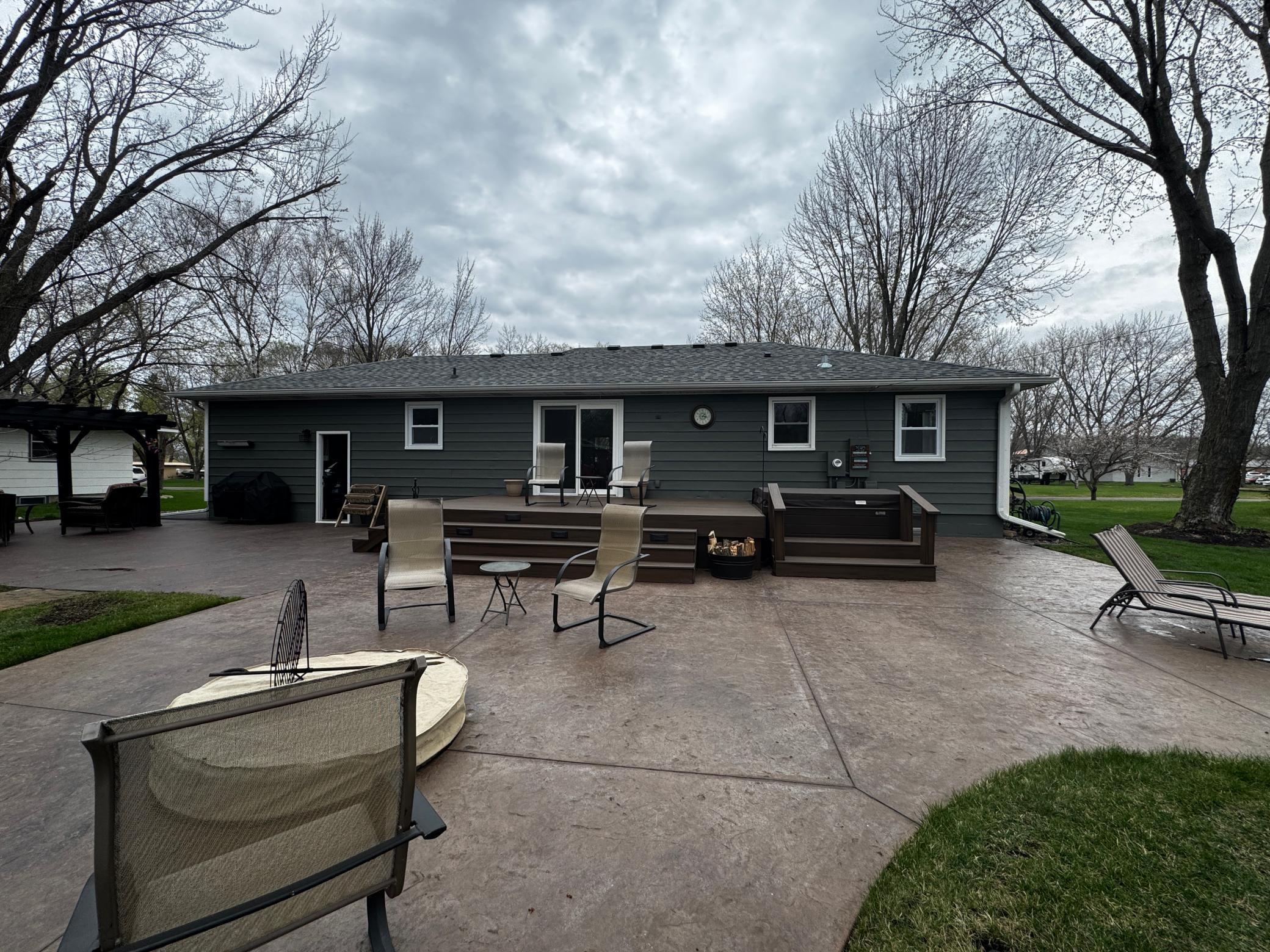 Stamped concrete patio, firepit and low maintenance deck.