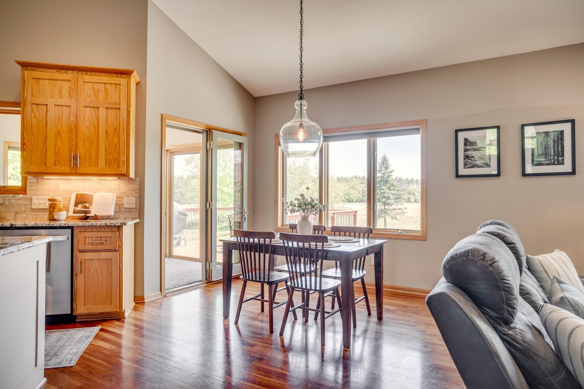 Dining area located off the kitchen and sunroom, overlooking the patio and surrounding landscape