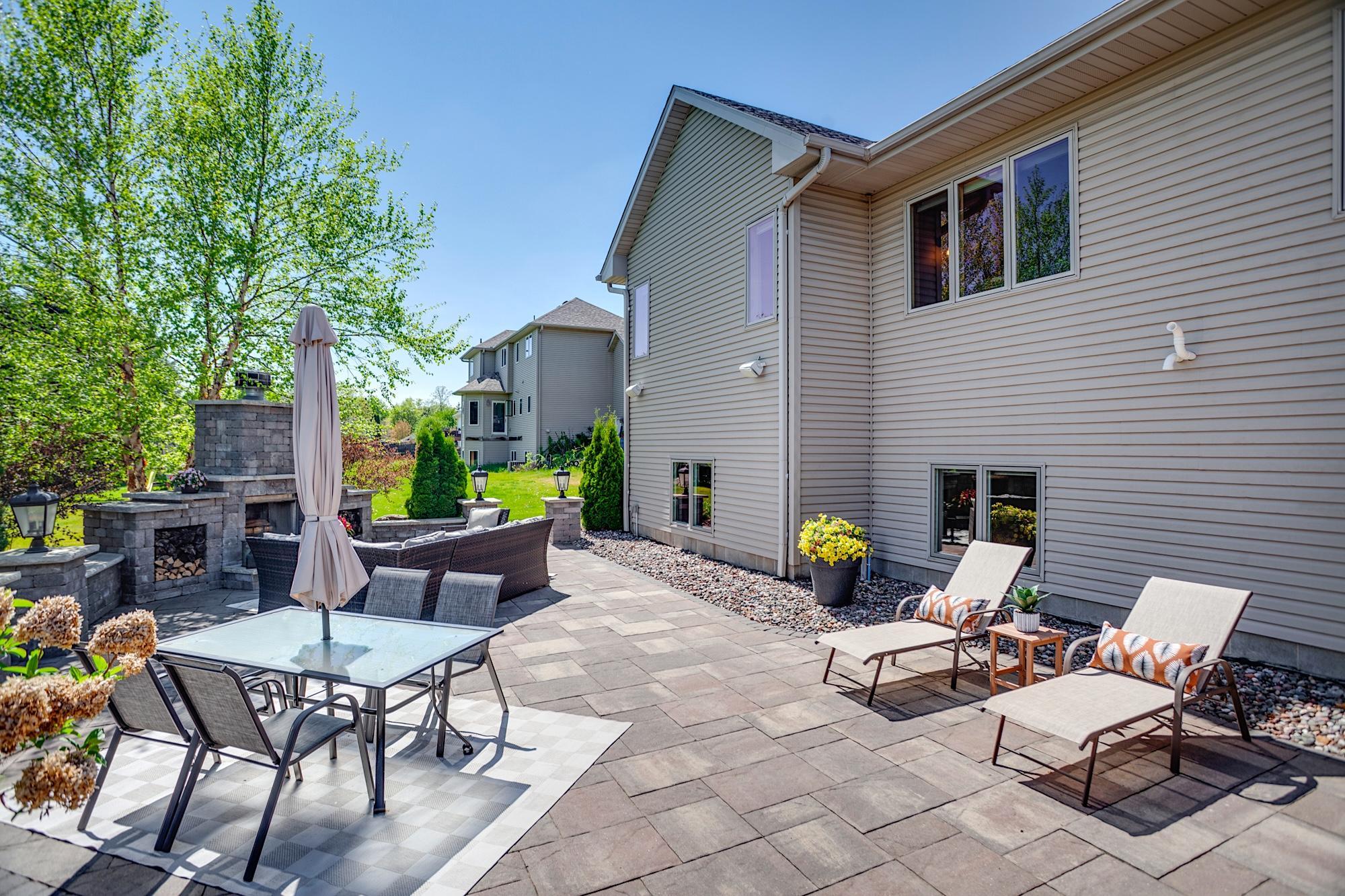 Stunning stone patio with a freestanding wood-burning fireplace and outdoor prep/serving area
