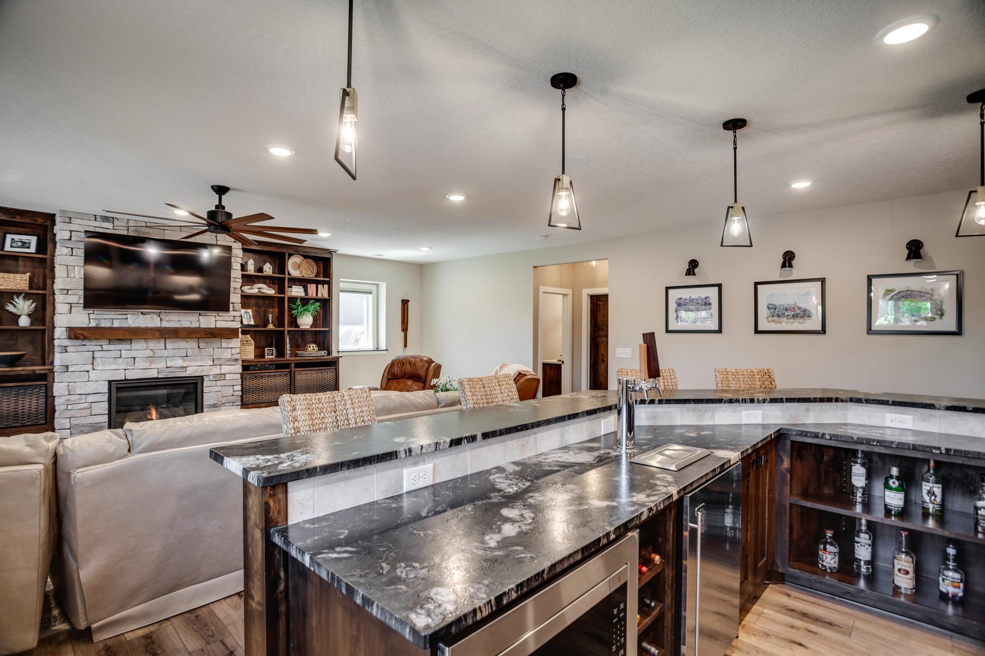 Full-size bar and kitchenette with refrigerator, sink, dishwasher and more