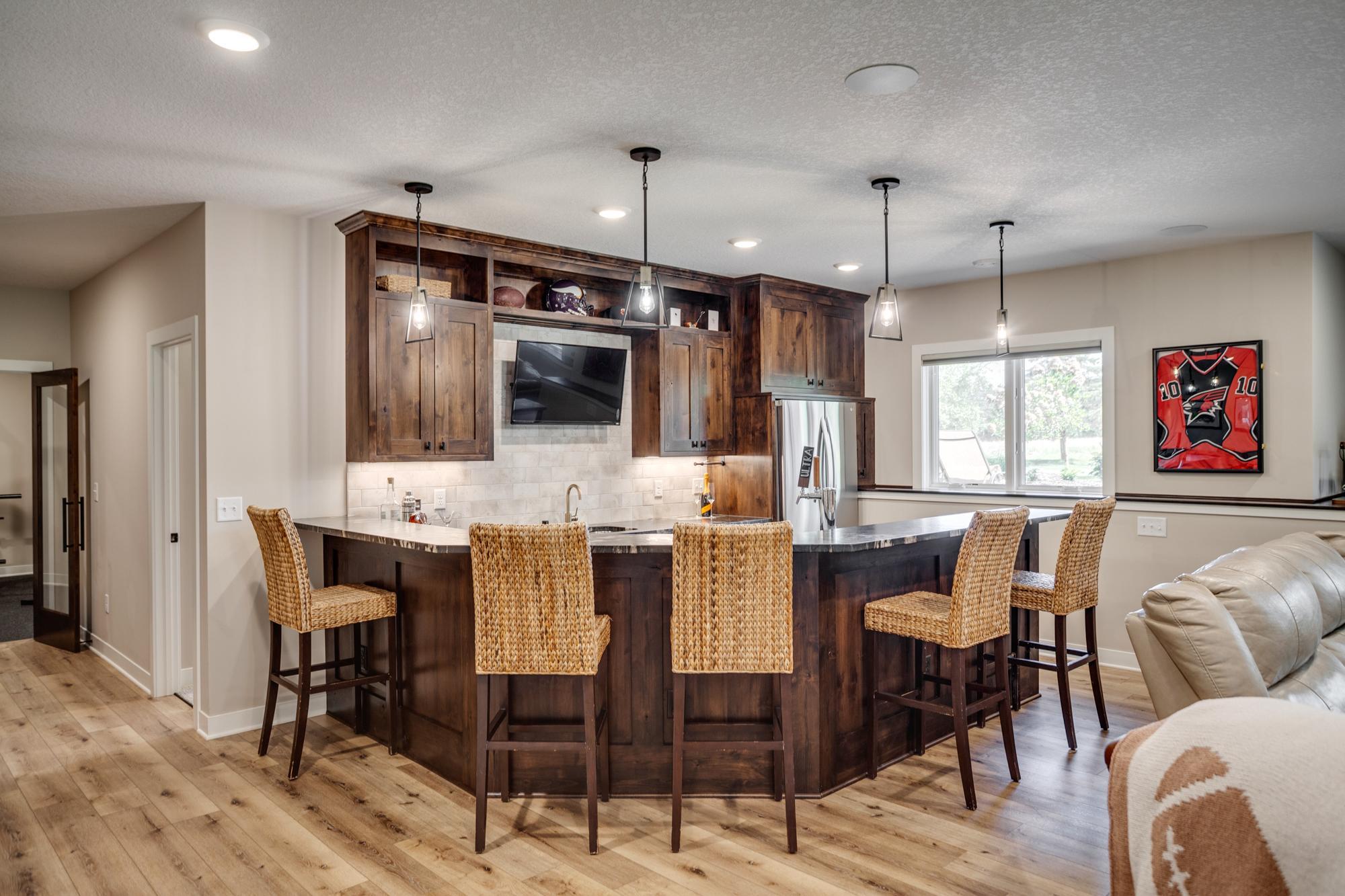 Full-size bar and kitchenette with refrigerator, sink, dishwasher and more