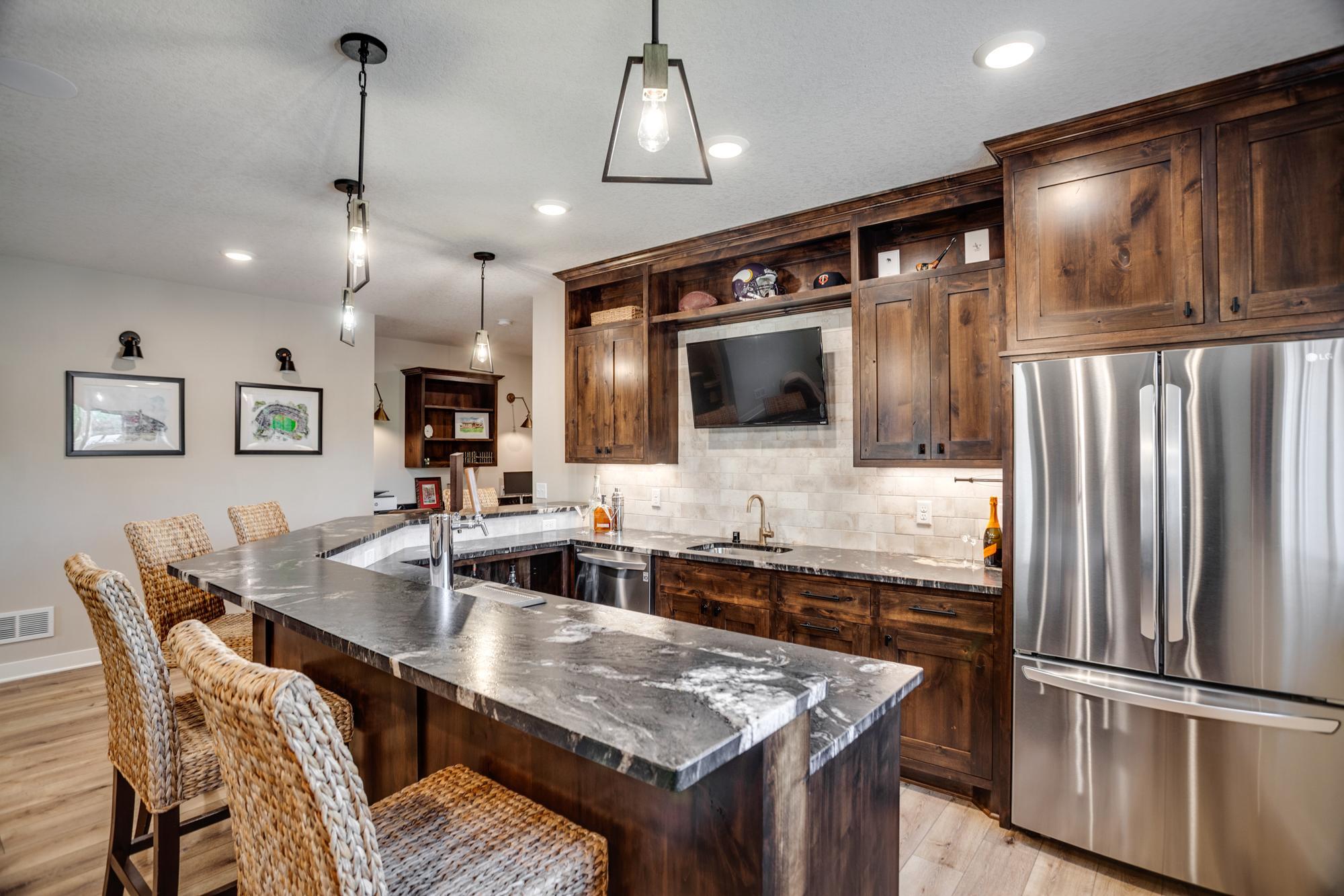 Full-size bar and kitchenette with refrigerator, sink, dishwasher and more