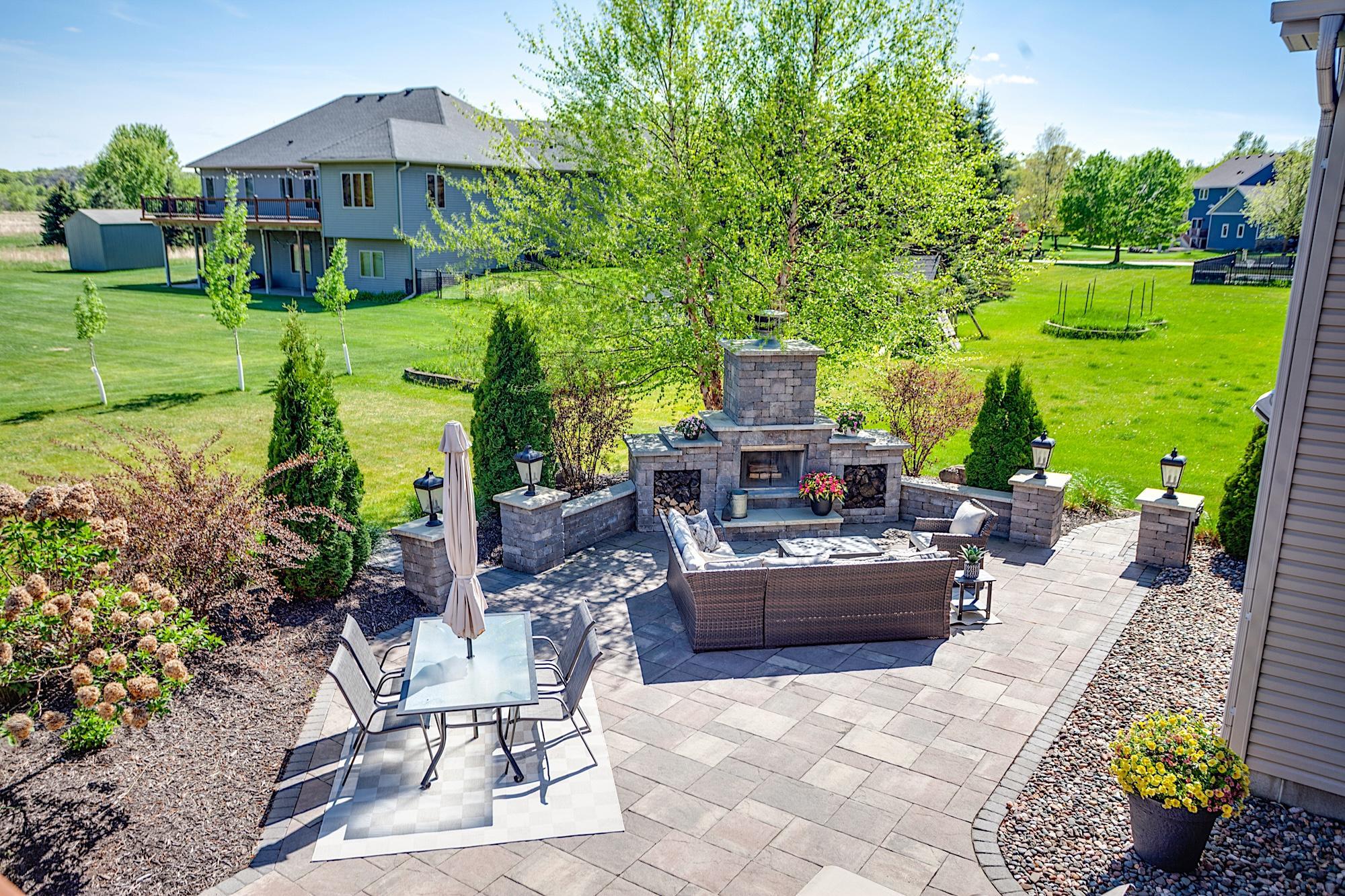 Stunning stone patio with a freestanding wood-burning fireplace and outdoor prep/serving area
