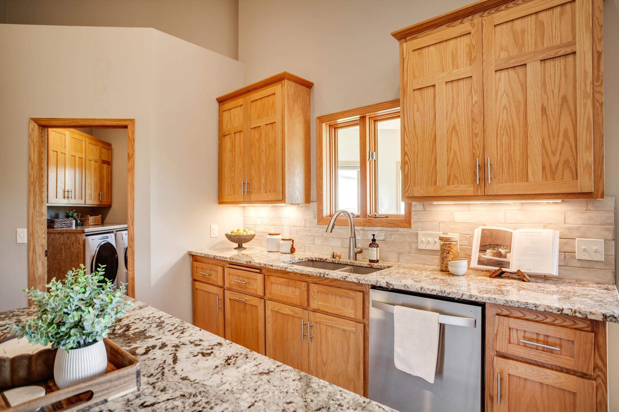 Gourmet kitchen equipped with granite countertops, stainless-steel appliances, a double oven and center island