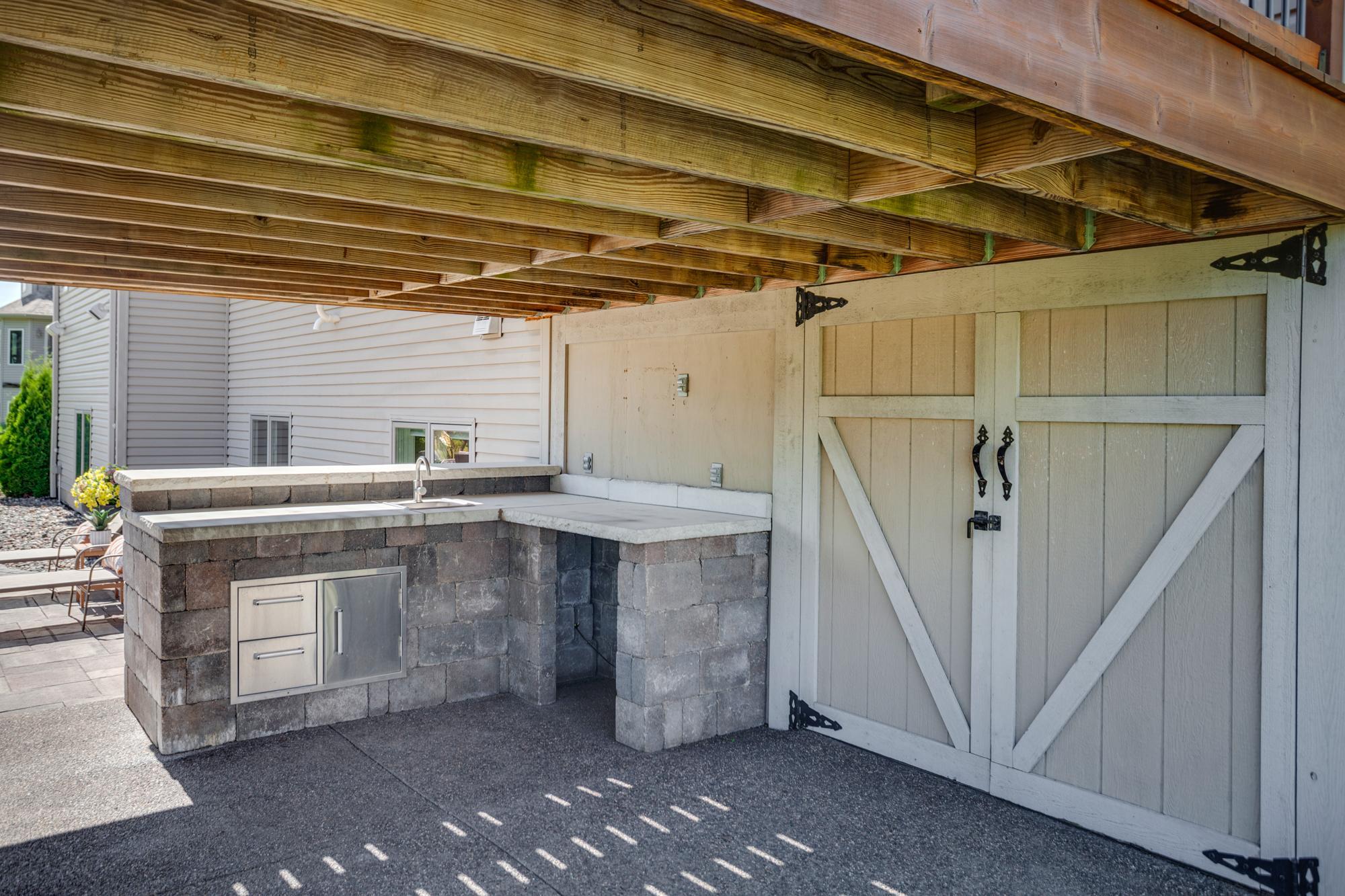 Built-in outdoor prep/serving area and tuck-under shed with electricity
