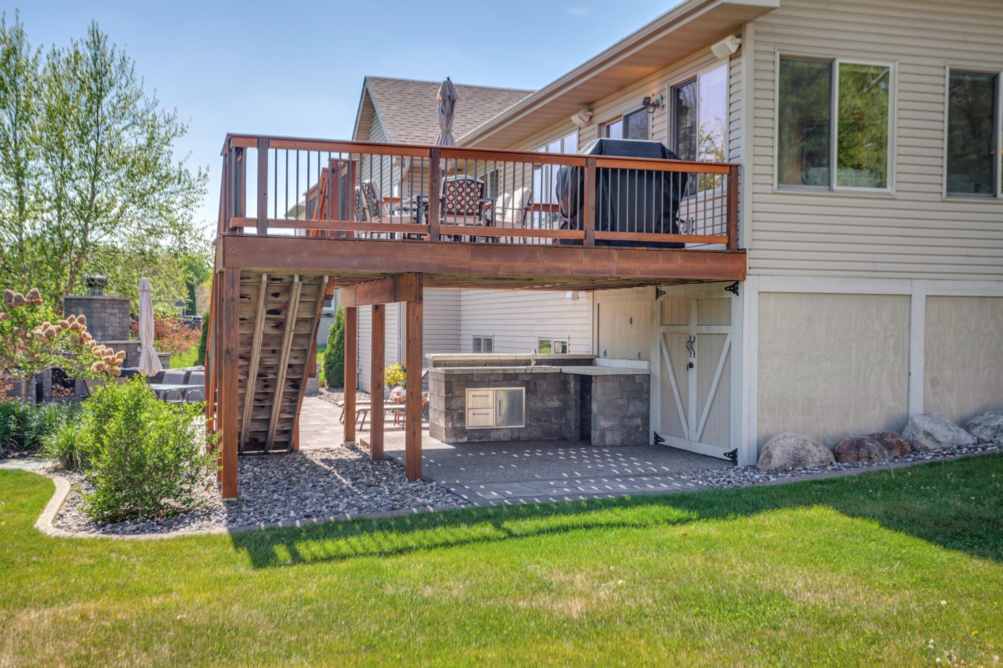 Built-in outdoor prep/serving area and tuck-under shed with electricity located under the deck