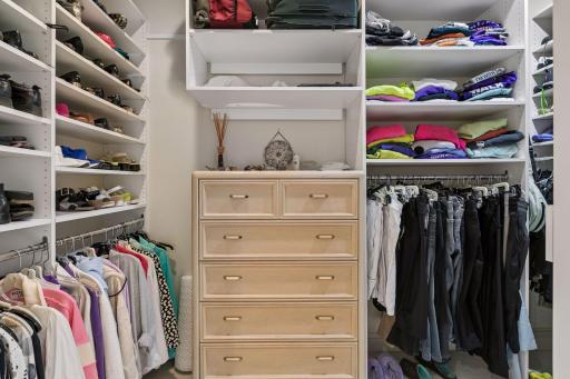 Primary walk-in closet with plenty of built ins