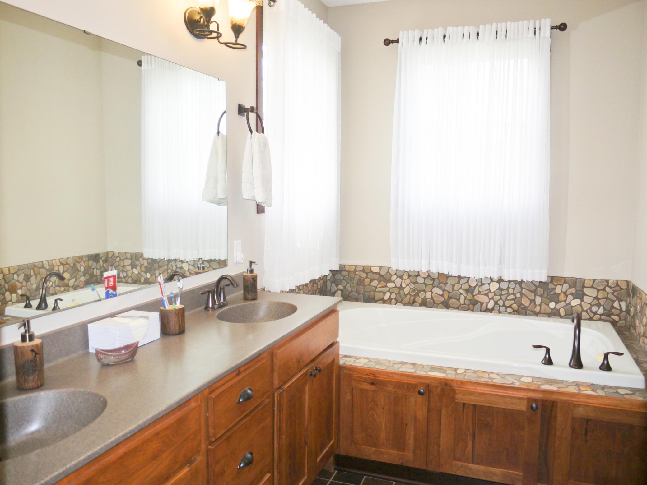 In suite bath with double sinks, soaking tub, seperate shower and walk-in closet.jpg