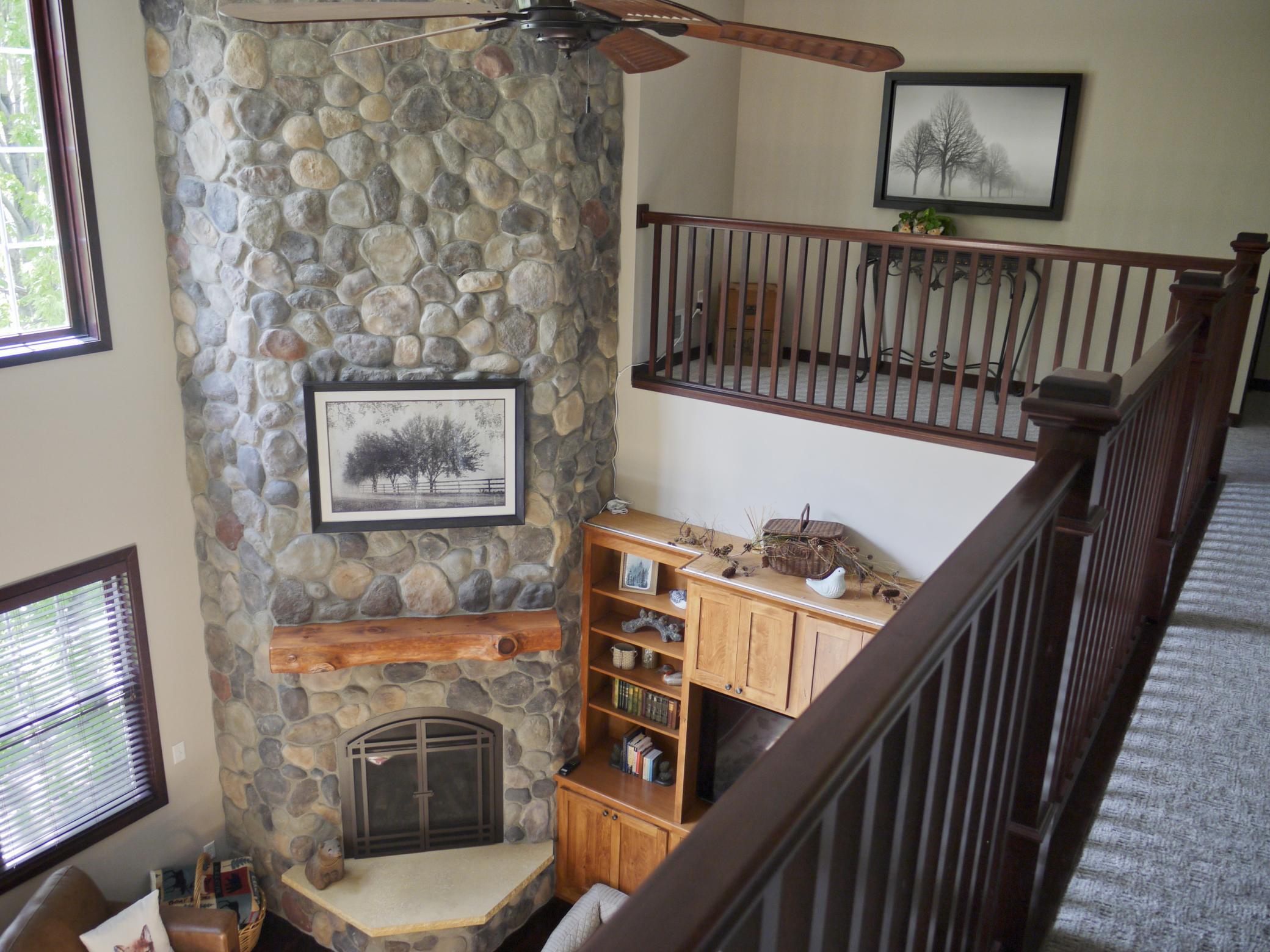 Balcony overlook of great room fireplace.jpg