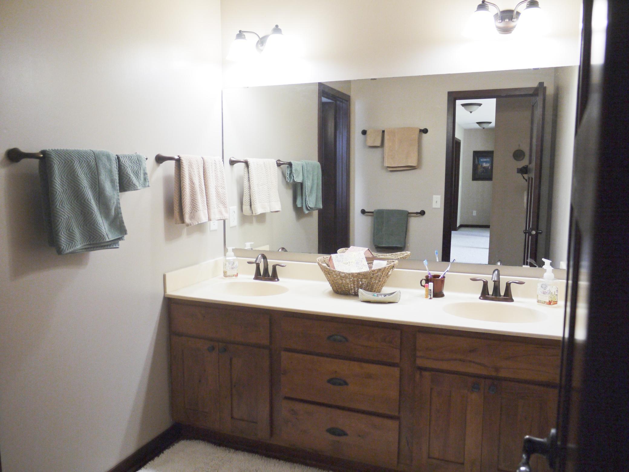 Upper level main bath with double sinks and seperate tub and toilet area.jpg