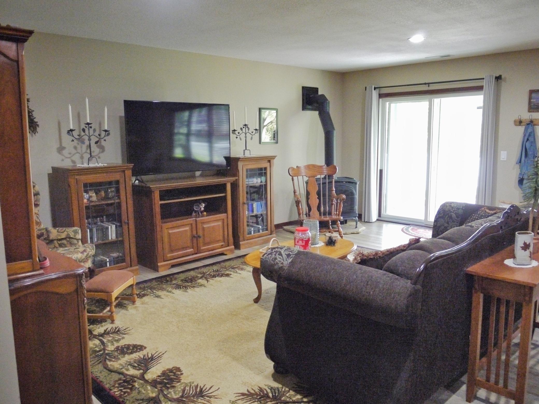 Lower level family room with gas fired wood stove and walkout to rear patio.jpg