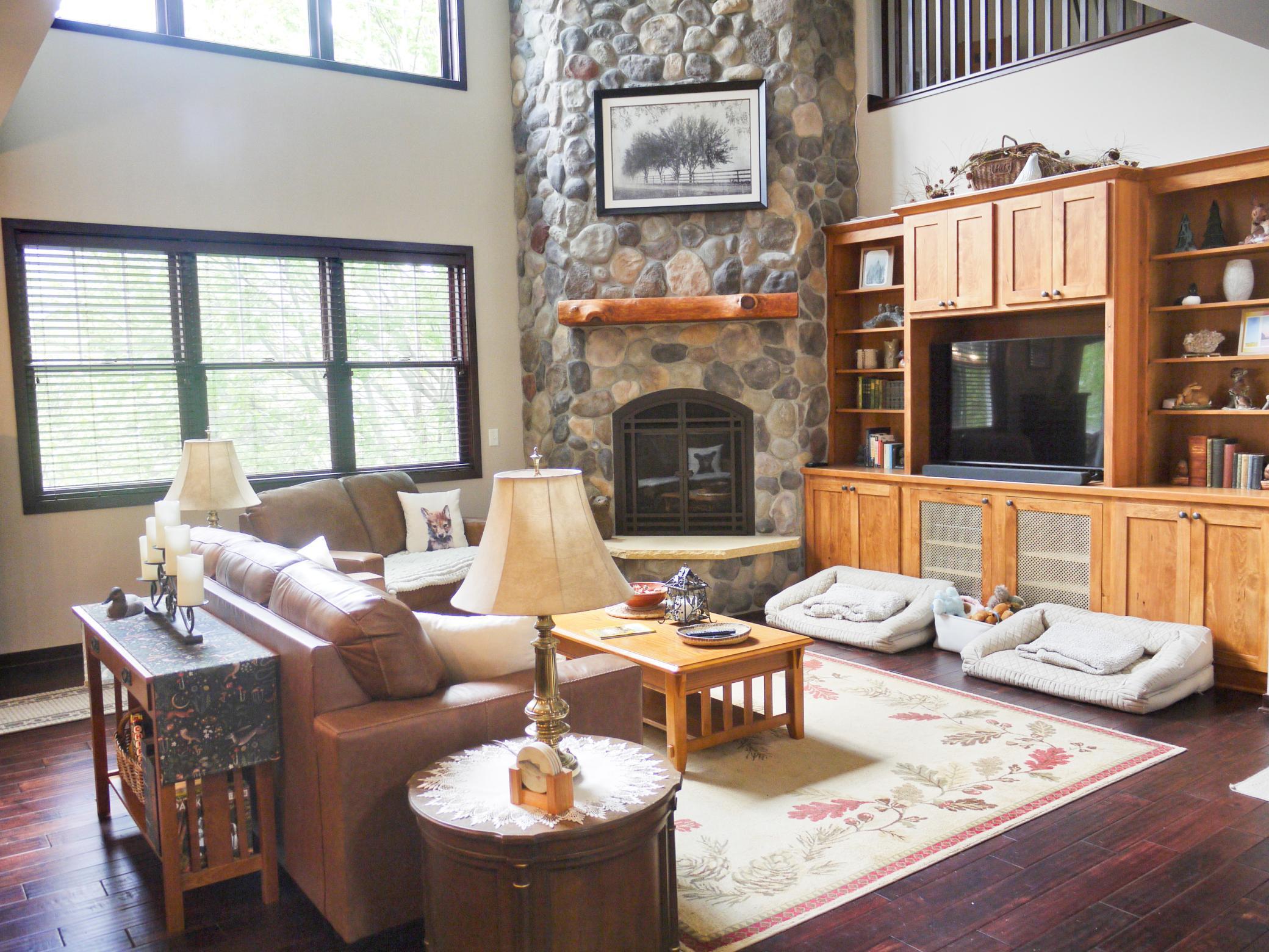 View of great room with 2 story fieldstone fireplace and entertainment center.jpg