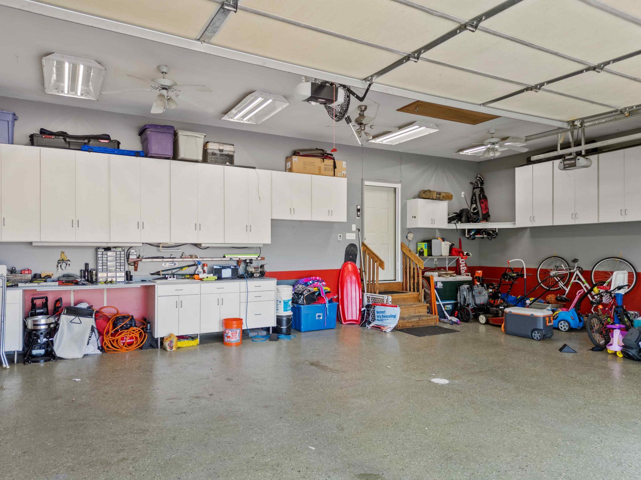 3 car garage with in-floor heat and walls of storage cabinets