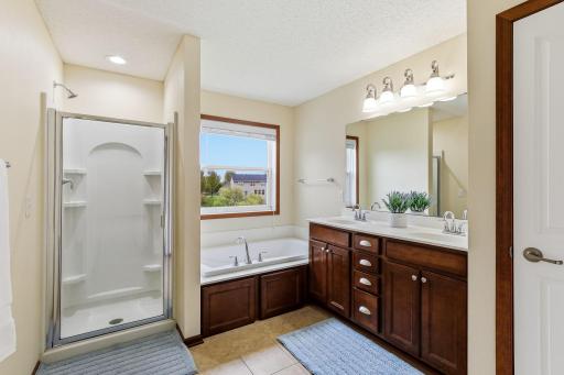 Master bath with double vanity, soaking tub, and separate shower - 18849-64th-Ave-32.jpg