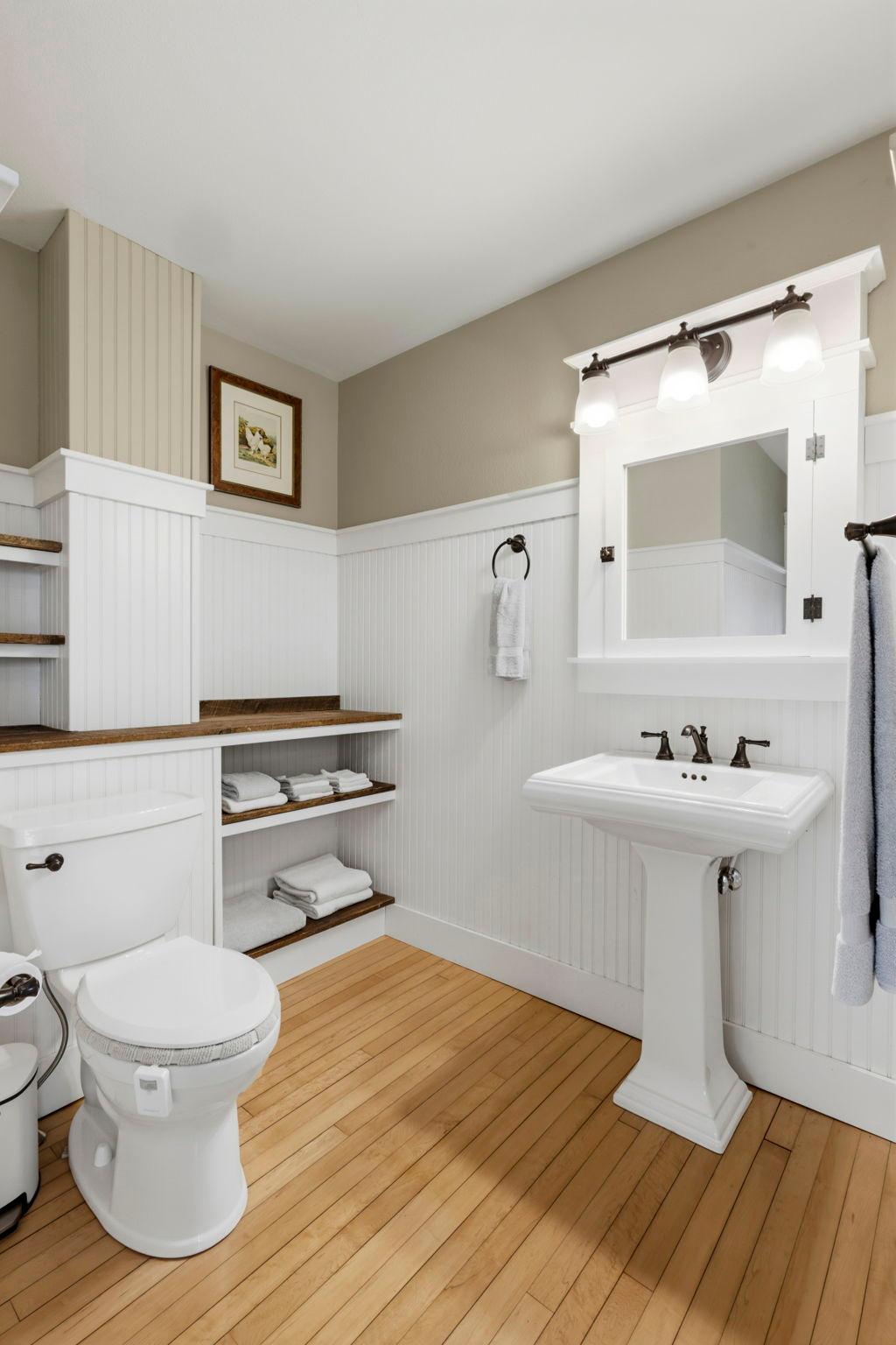 Thoughtful built-ins and timeless finishes bring both character and function to this inviting bathroom space.