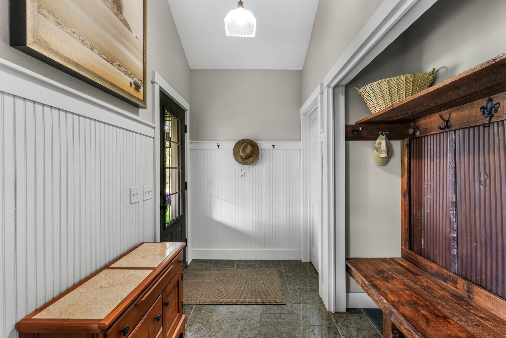 Functional mudroom entry featuring beadboard detail, built-in storage, and rustic touches