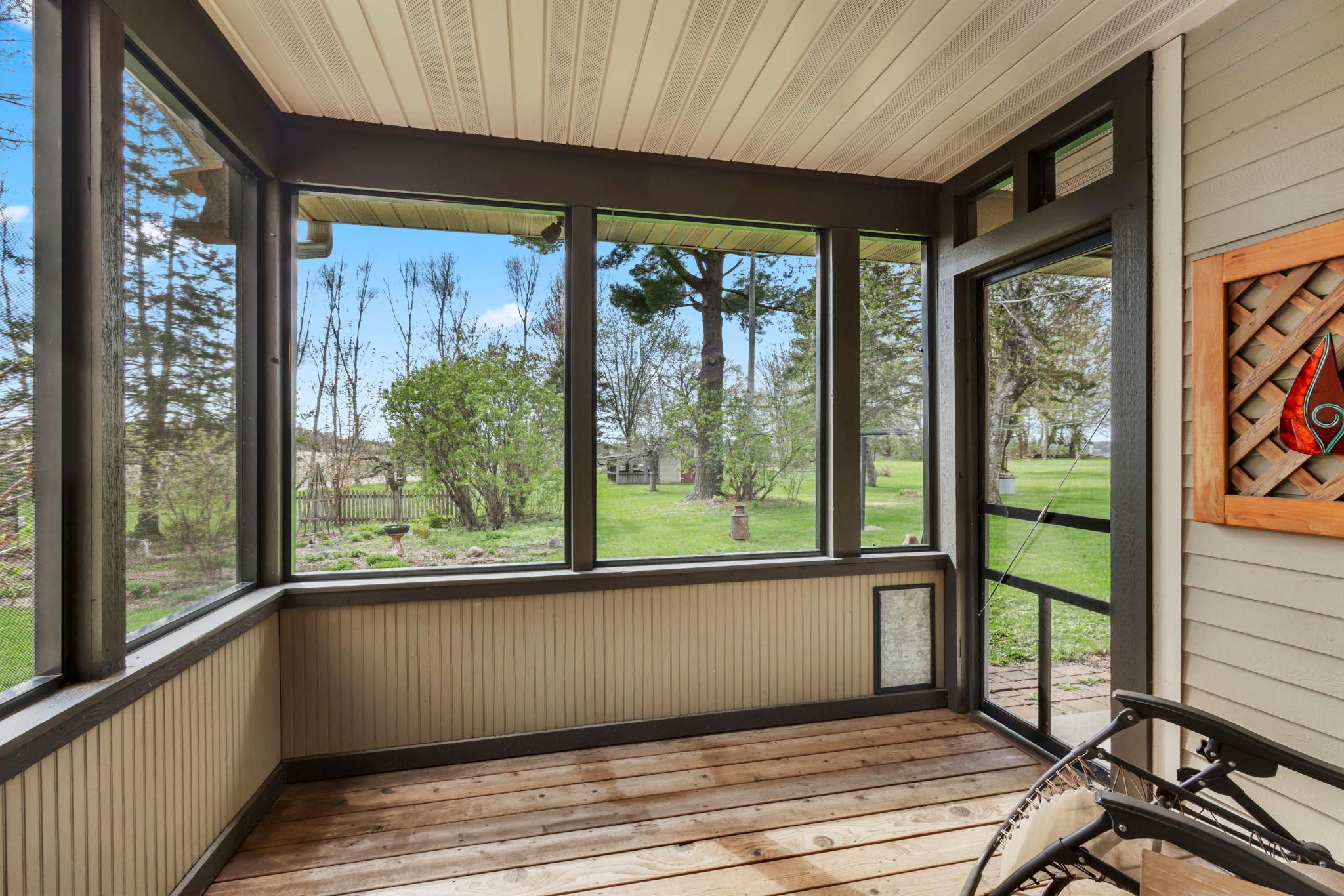 Relax and unwind in the screened porch overlooking the scenic countryside and mature landscaping.