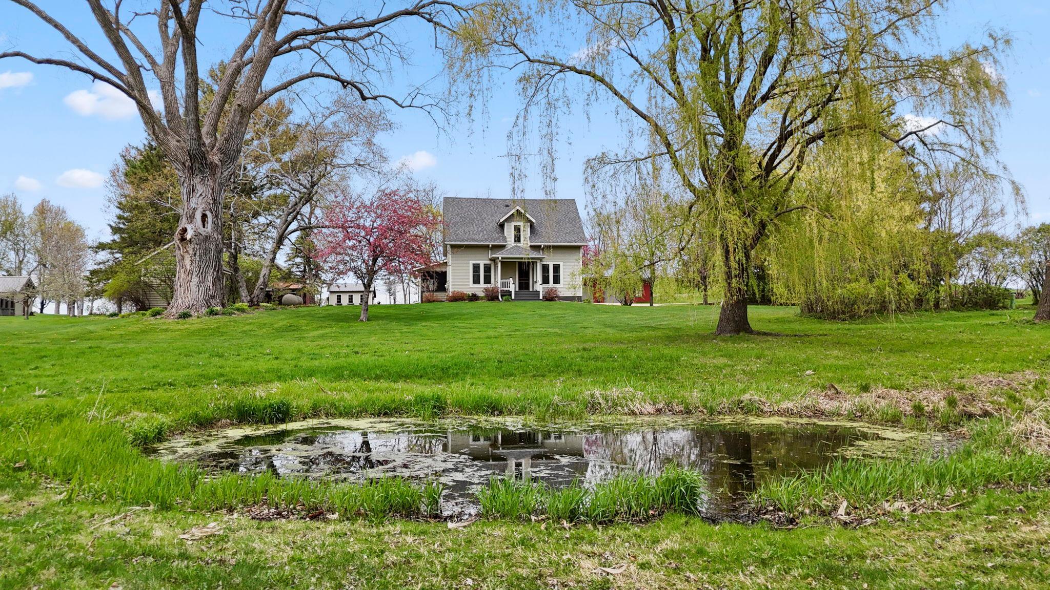 Peaceful country setting with picturesque pond, mature trees and charming farmhouse views.
