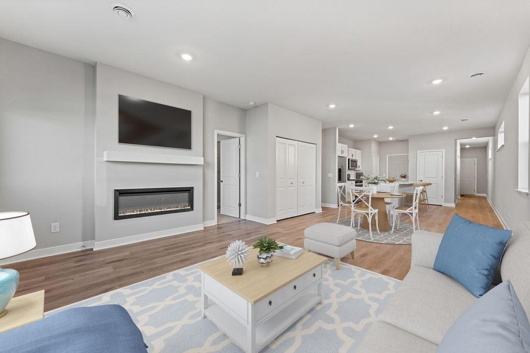 Open and bright, the living space is suitable for entertaining or just relaxing! Virtually staged photo, color and finish will vary.