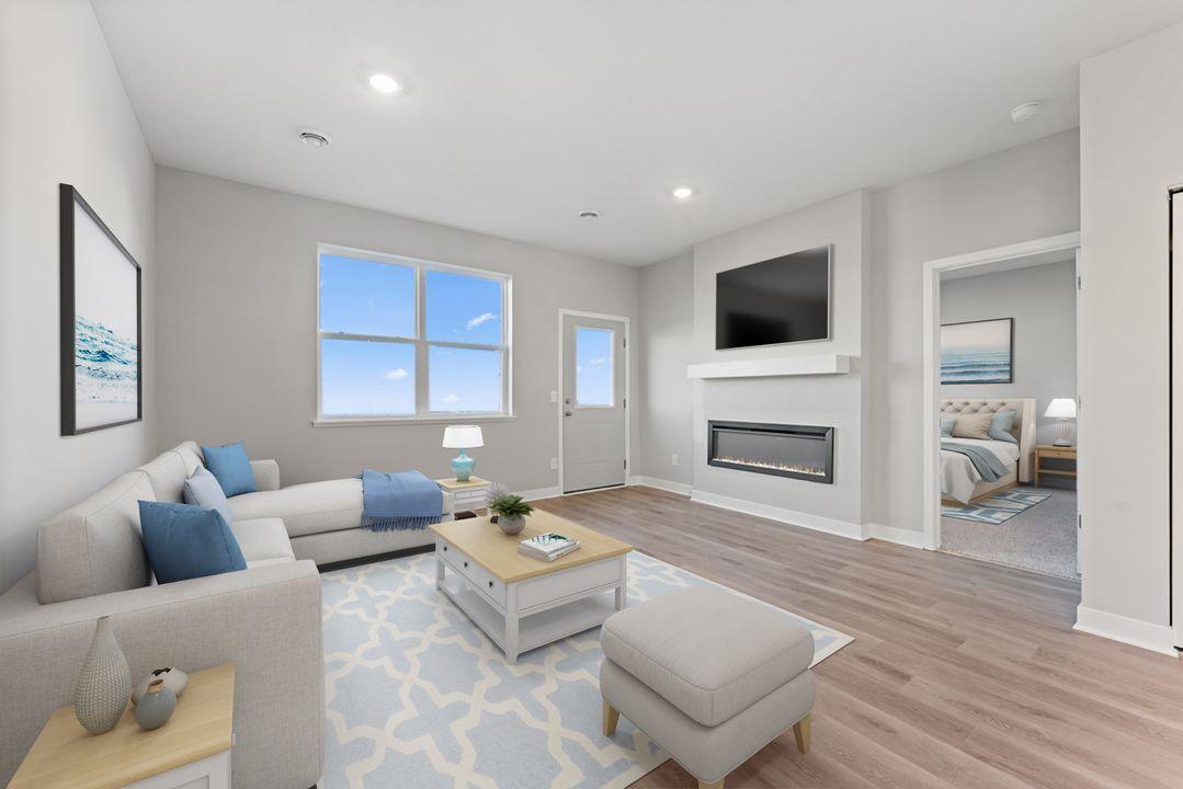 An elegant electric fireplace provides ambiance in this charming living room! Virtually staged photo, color and finish will vary.