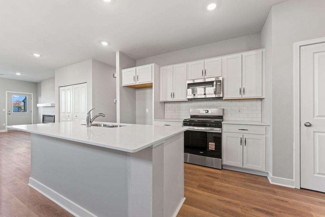 Quartz countertops and kitchen backsplash are just a couple of the design details that will have your kitchen feeling upscale! Spec home. Actual home is under construction - color and finish will vary.