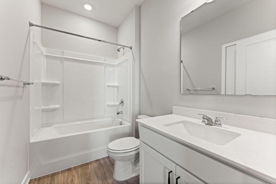 The second bathroom with tub/shower combo. Spec home. Actual home is under construction - color and finish will vary.