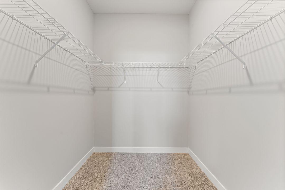 A generous primary walk-in closet! Spec home. Actual home is under construction - color and finish will vary.