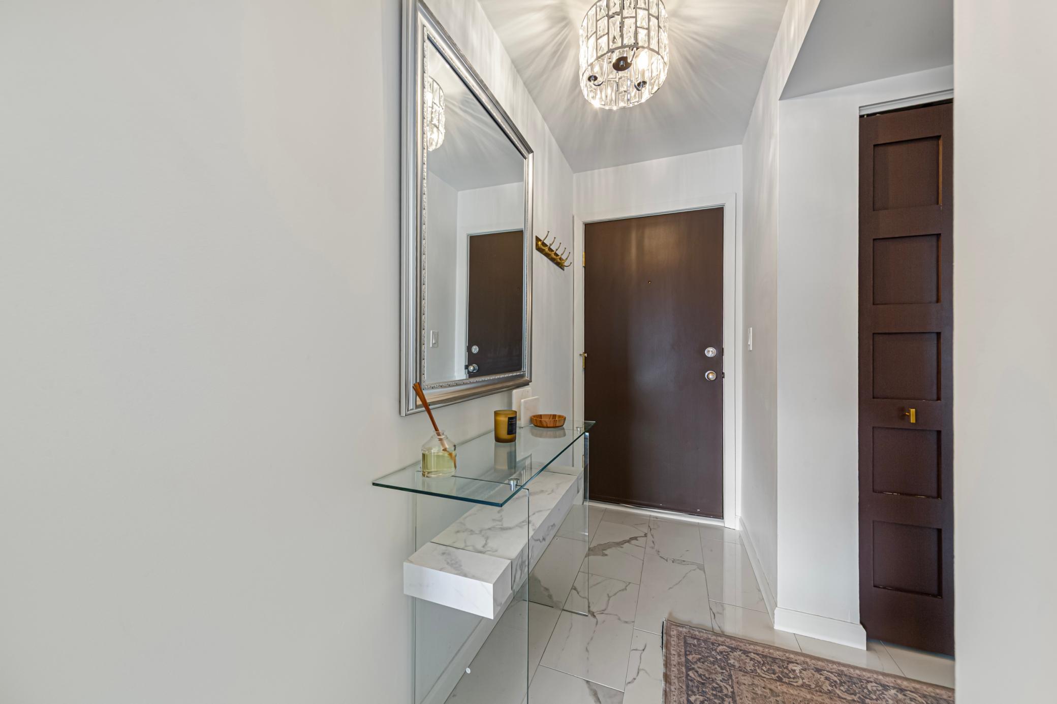 Lovely entry with upgraded flooring, doors and lighting