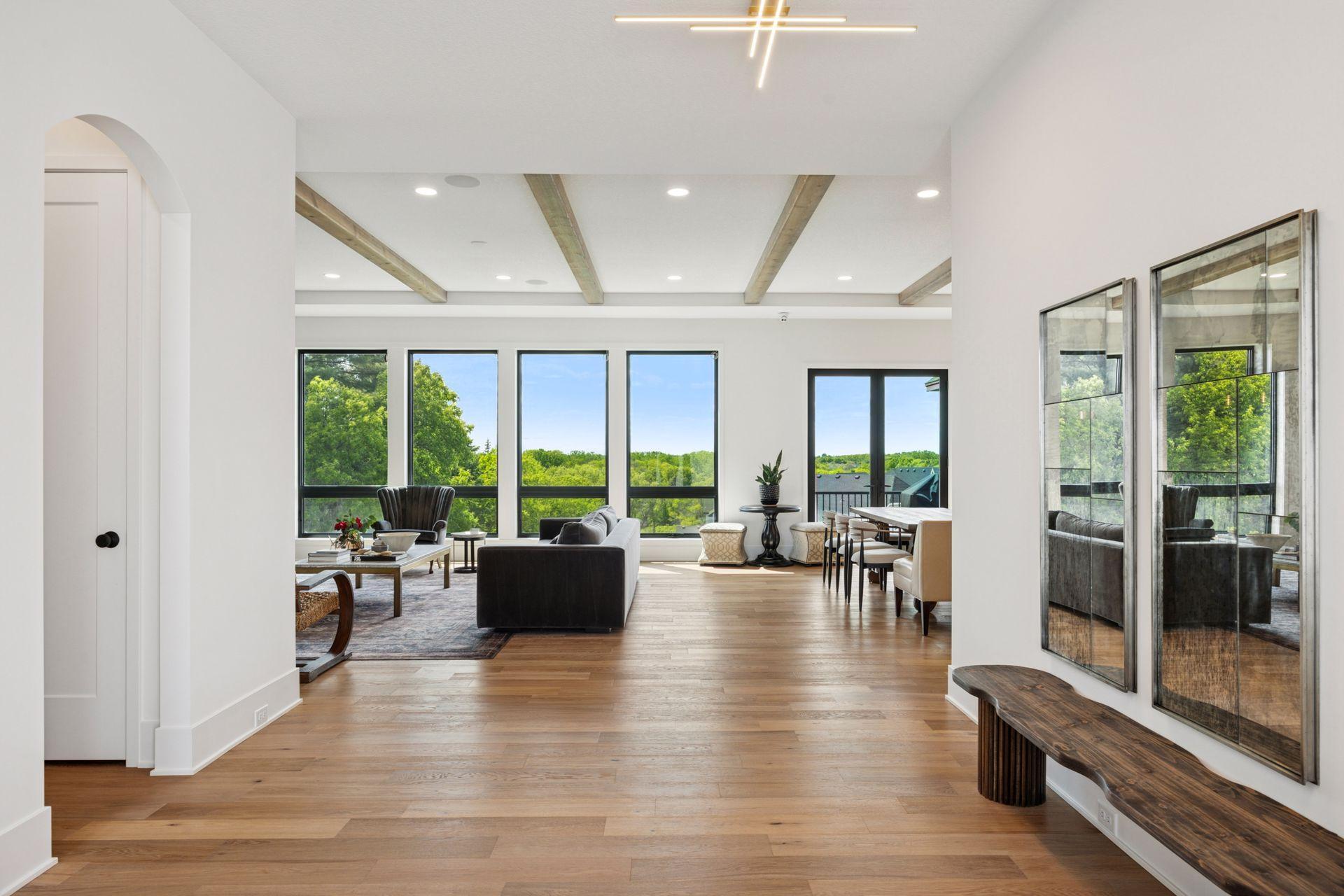 Walls of windows with treetop views off the back of the home