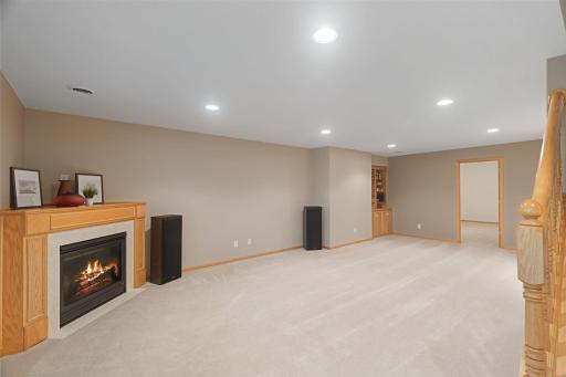 Huge lower-level family room with fireplace, built-ins, and plenty of room for entertaining or relaxing.