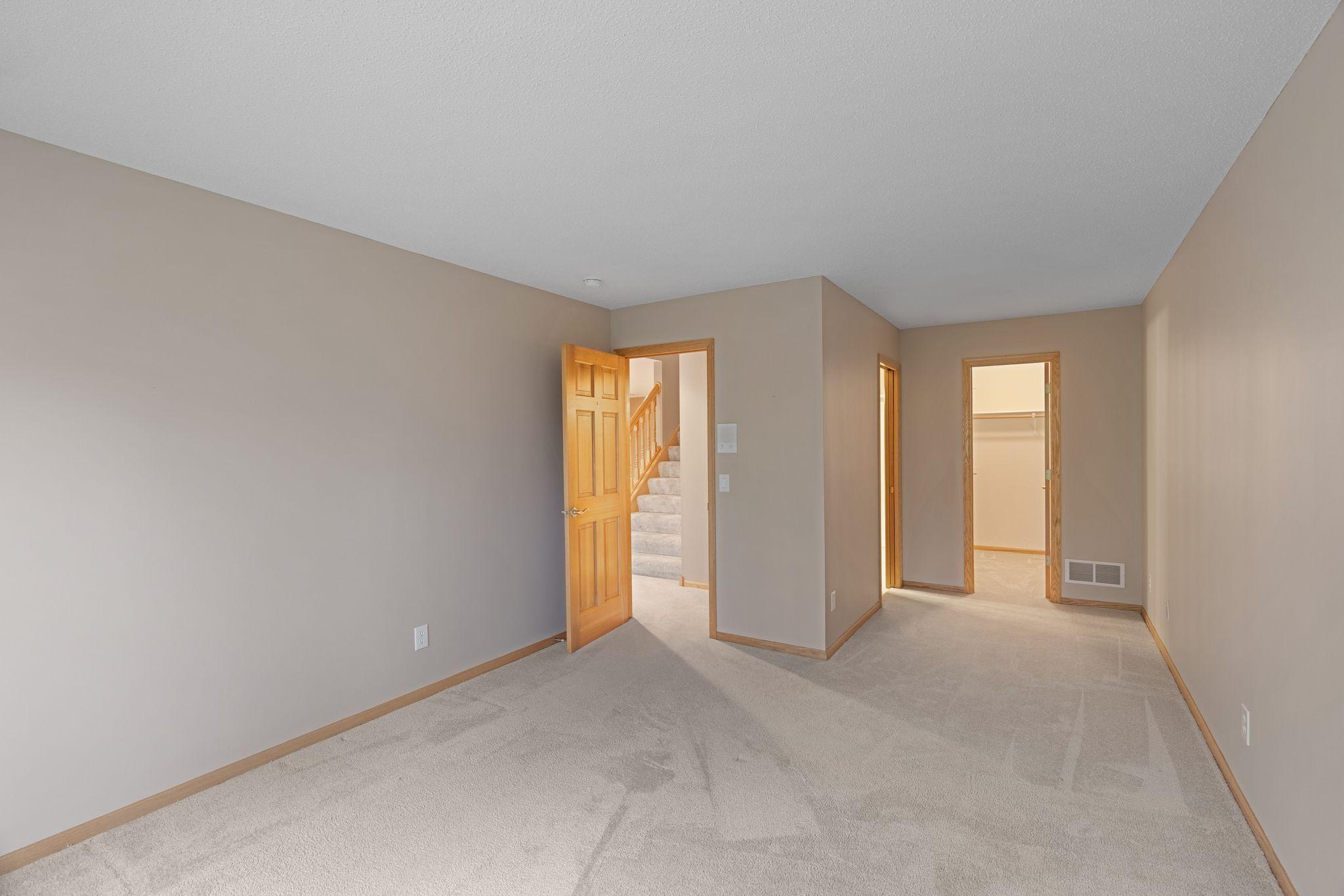 Spacious lower-level bedroom with large walk-in closet and direct access to lower level bath.