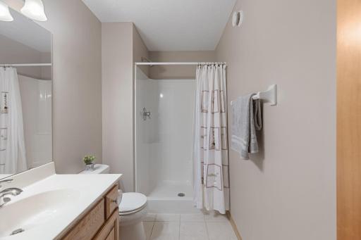 Additional lower-level full bathroom for guests or family convenience.