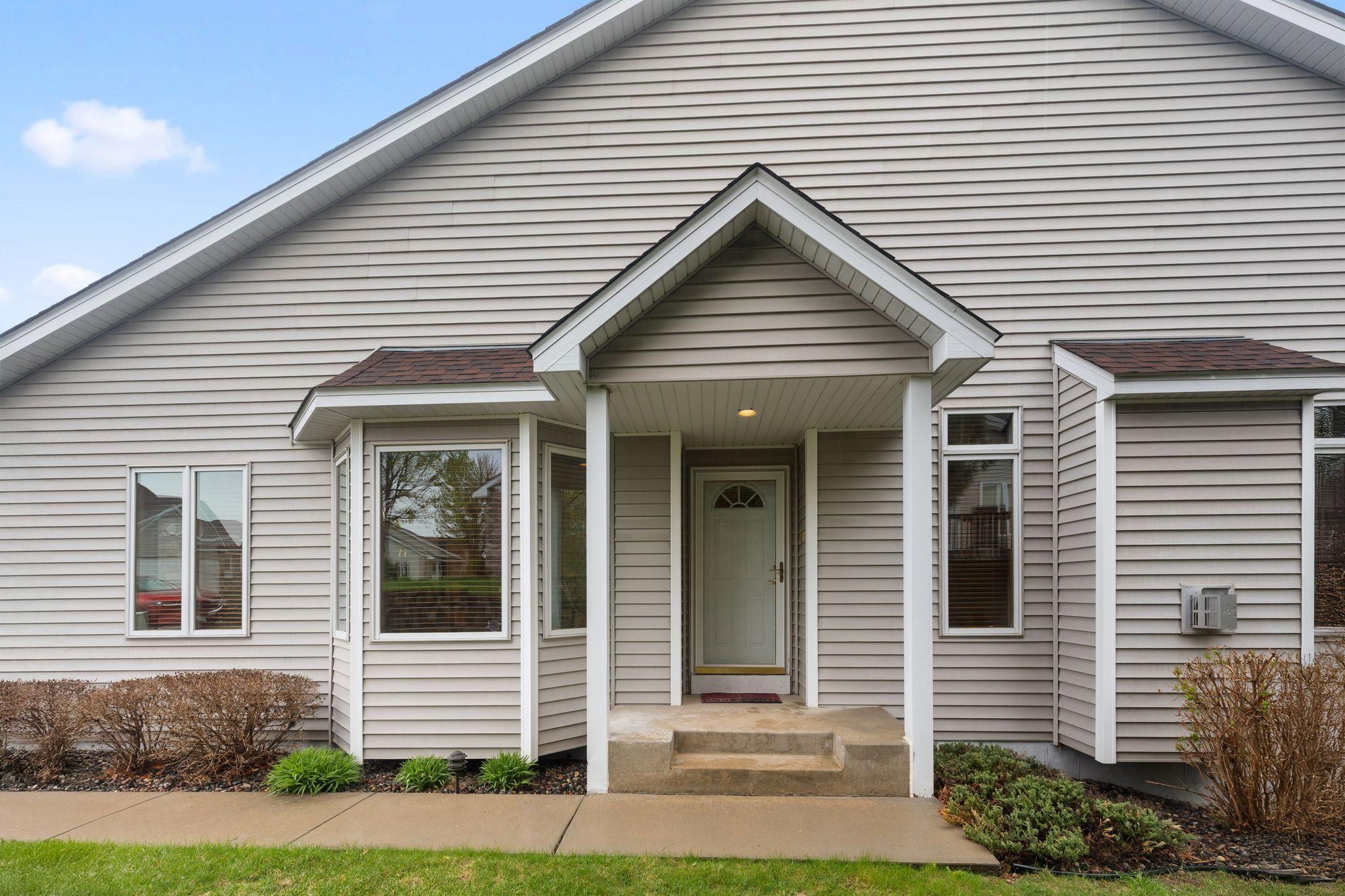 Welcoming covered front entry with charming curb appeal and low-maintenance exterior.