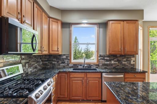 Beautiful kitchen with back splash, solid surface counters and newer appliances.