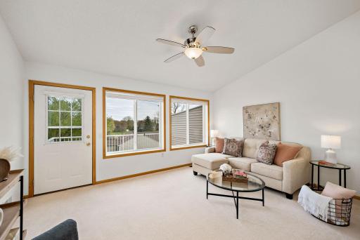 Enjoy this sunroom overlooking private green space in the back