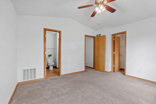 Primary bedroom with lots of natural light and ceiling fan