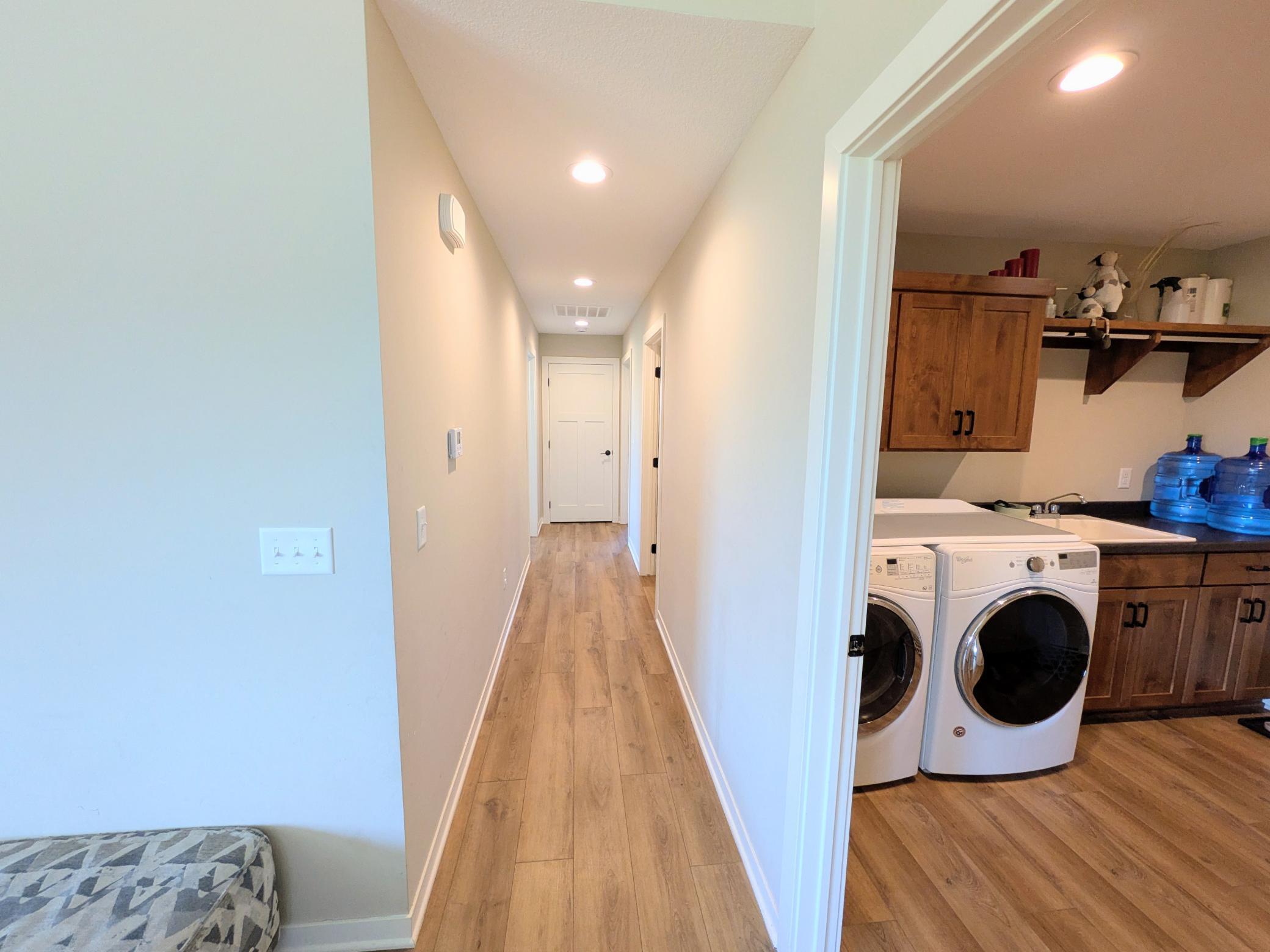 Hallway to laundry, bathroom, primary bedroom and bedroom #2