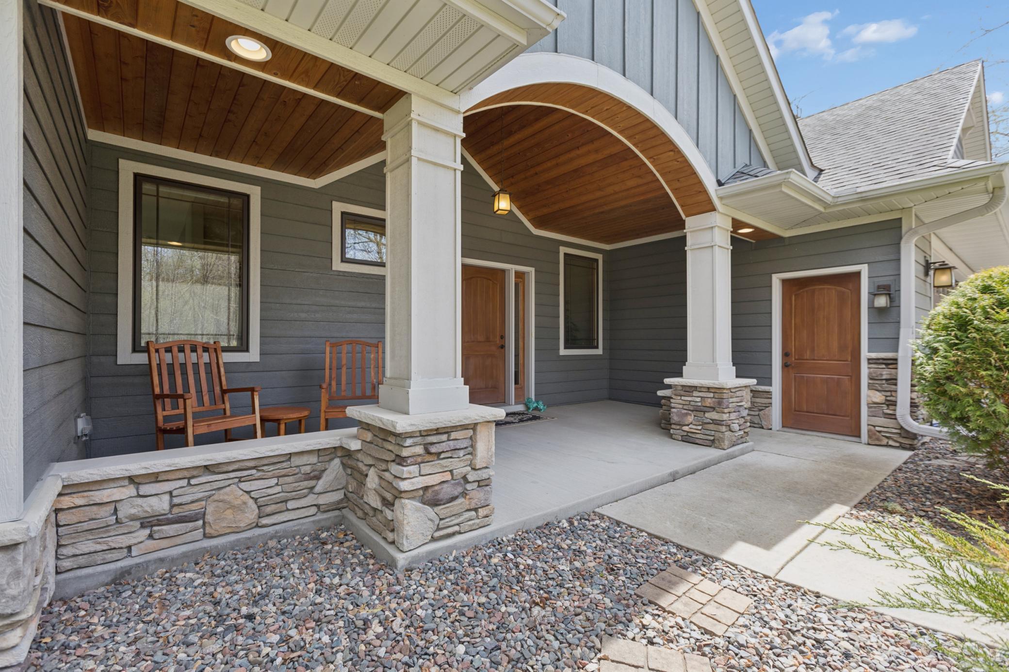 The front porch as you enter the property is spectacular! The details are remarkable. Lovely wood ceiling accents, stone and the lovely siding make this space pop!