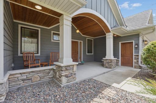 The front porch as you enter the property is spectacular! The details are remarkable. Lovely wood ceiling accents, stone and the lovely siding make this space pop!
