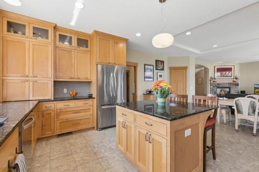 Another view of the kitchen. Love the cabinets that go all the way to the ceiling! There is a large pantry, lovely tile flooring and so much counter space too! What a gem this kitchen is!