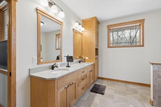 The main floor primary suite is amazing too! Double sinks, gorgeous cabinetry, heated floors and more pretty windows! So nice!
