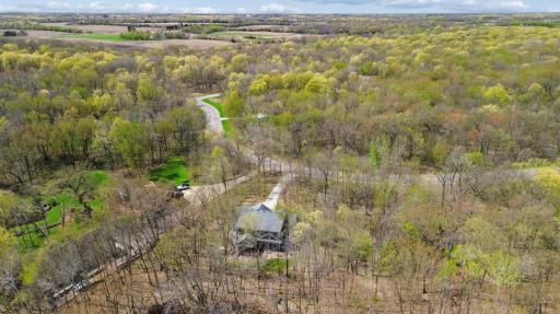 Aerial from back! Imagine how breathtaking the trees will be! Summer and fall may be your favorite seasons with all the beauty around this property!