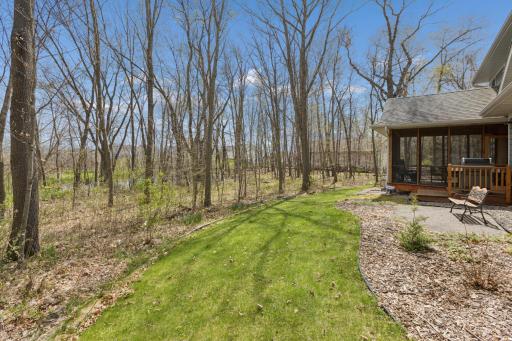 A view of the screen porch and backyard woods. Private and peaceful!